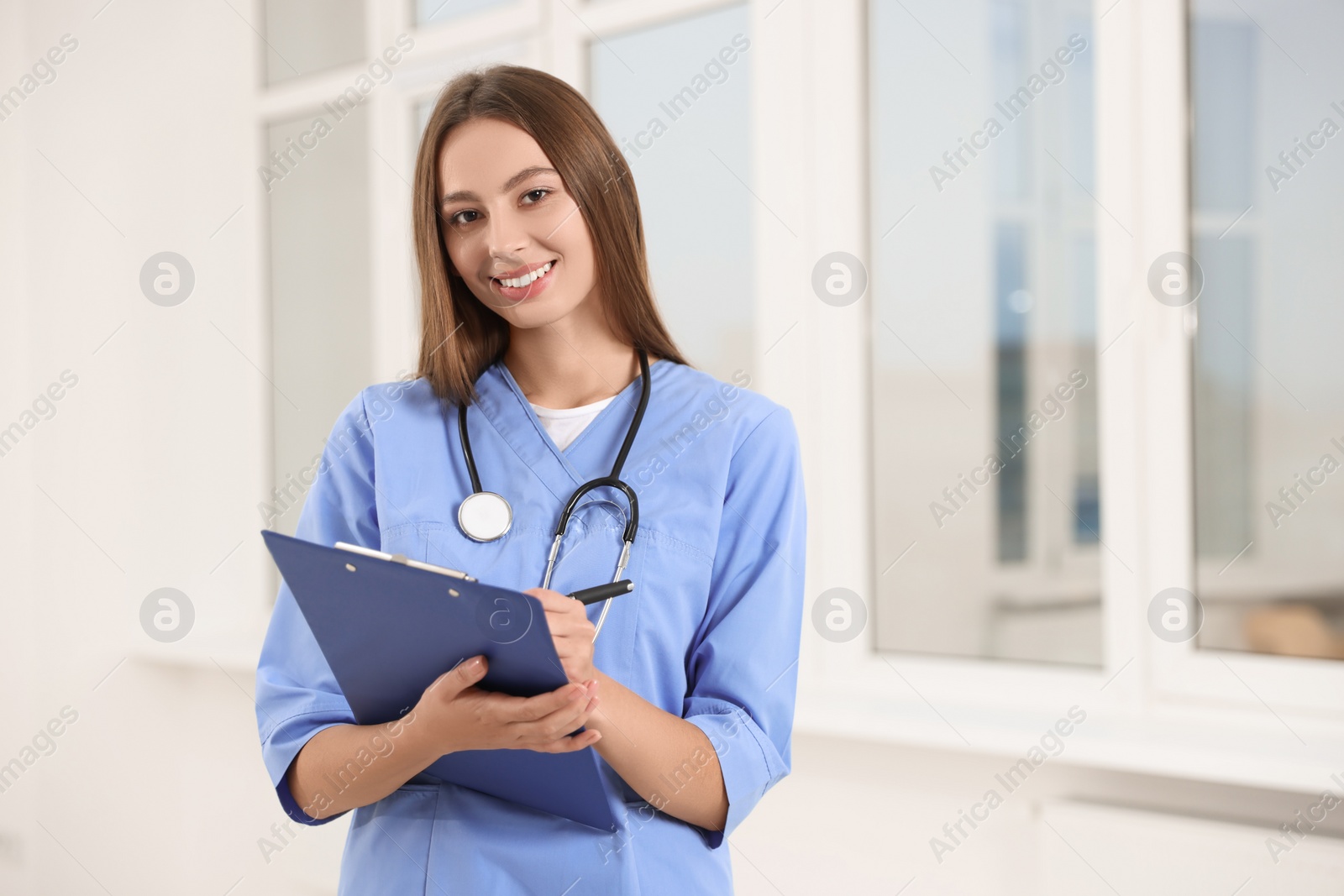 Photo of Portrait of young intern wearing uniform in university hall, space for text