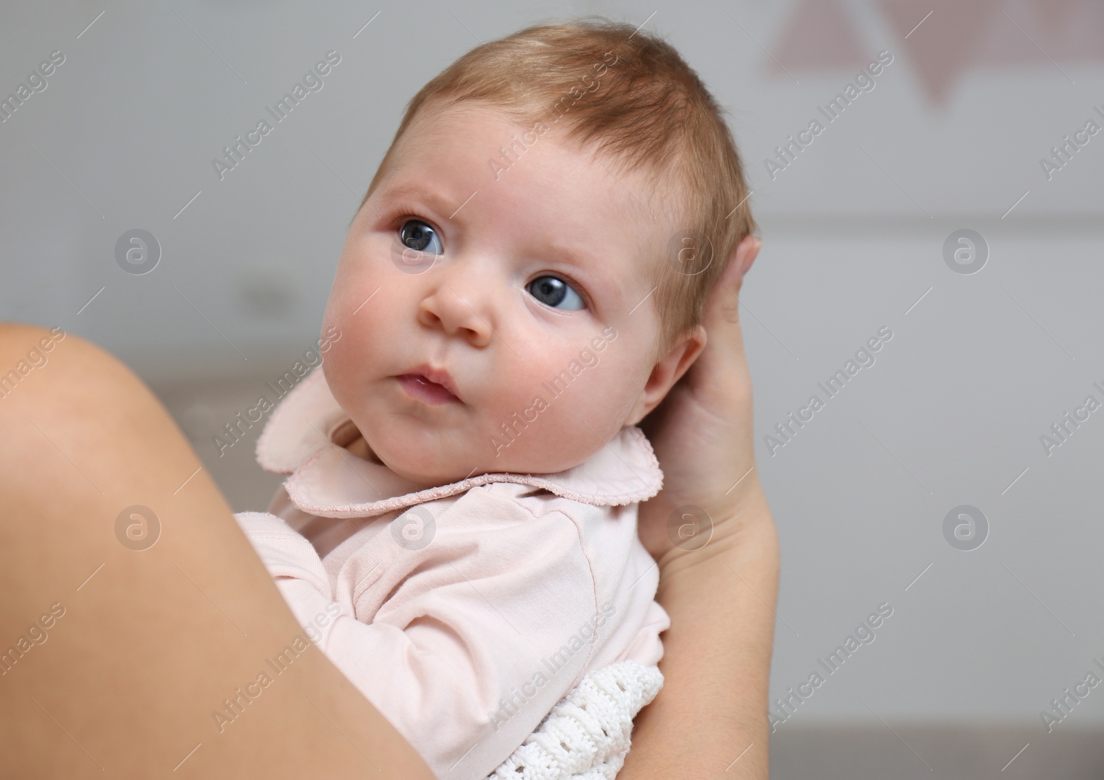 Photo of Young woman with her little baby resting after breast feeding at home, closeup