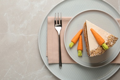 Photo of Plate with sweet carrot cake on white marble table, top view. Space for text