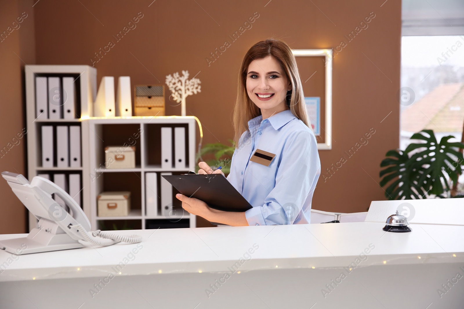 Photo of Female receptionist at hotel check-in counter