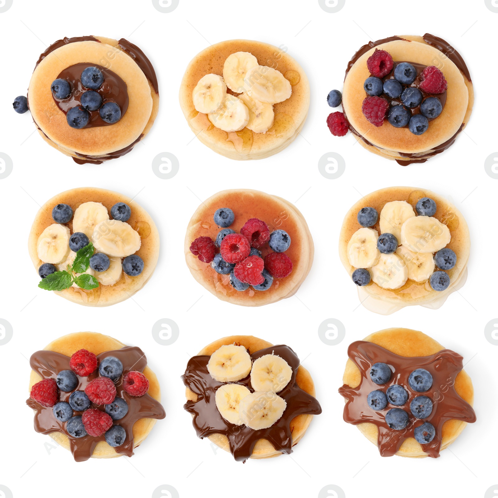 Image of Set of tasty pancakes with toppings isolated on white, top view