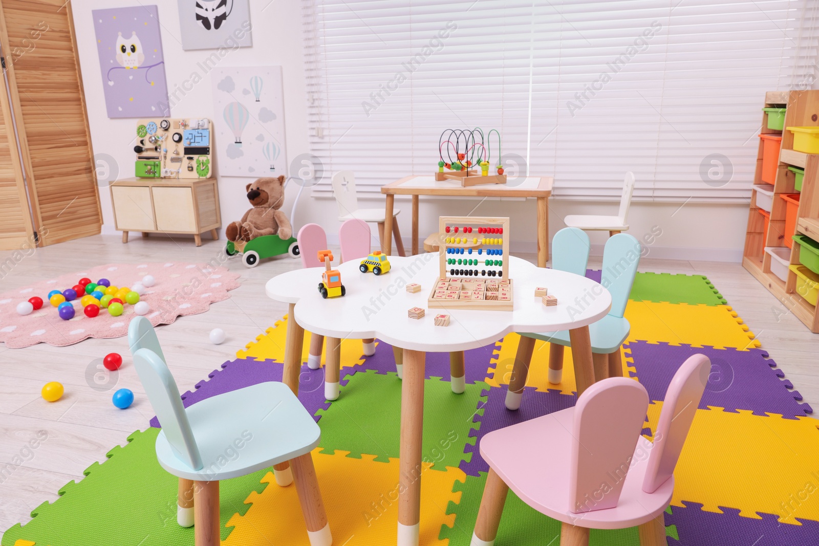 Photo of Stylish kindergarten interior with toys and modern furniture