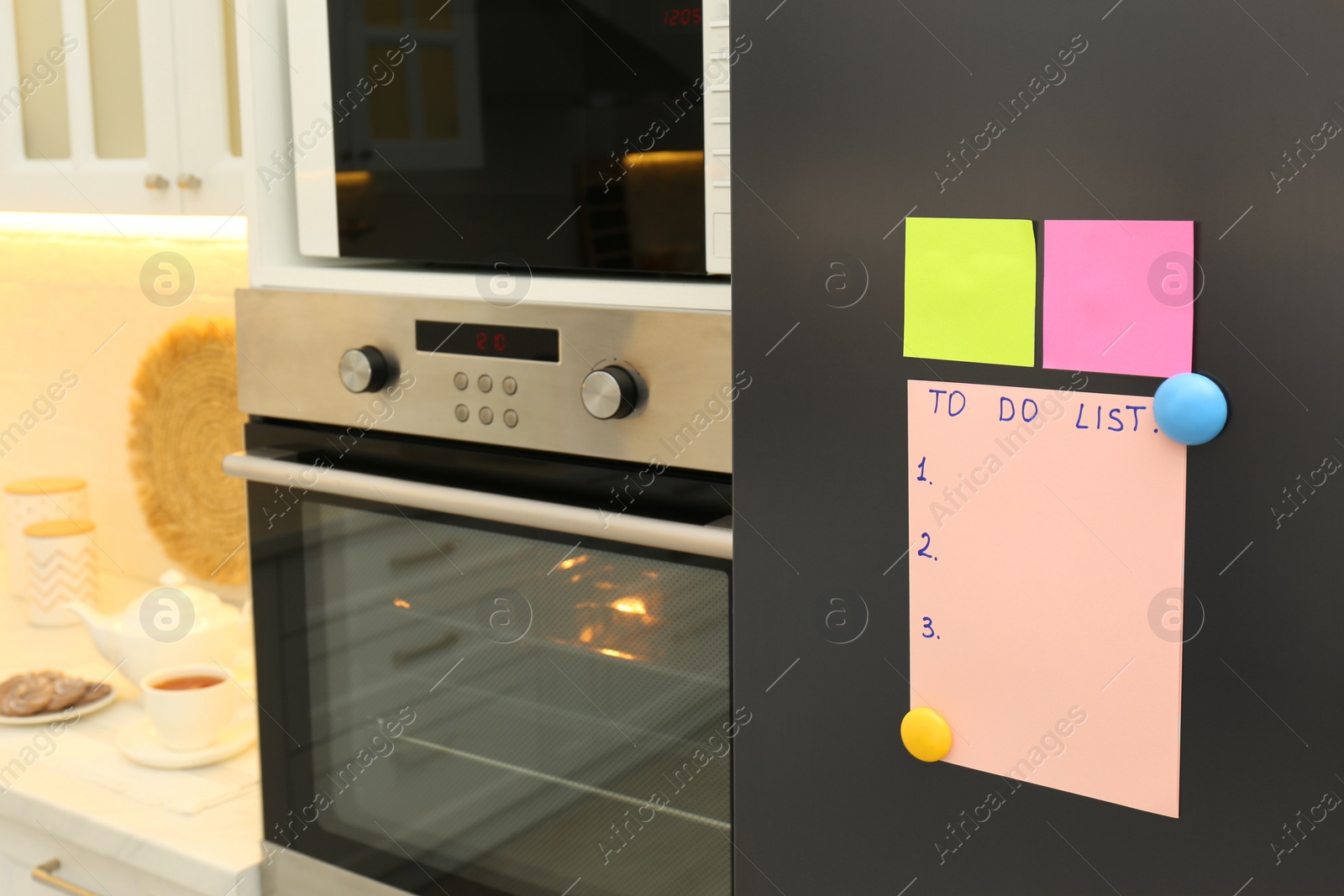 Photo of Blank To do list and sticky notes on fridge in kitchen. Space for text