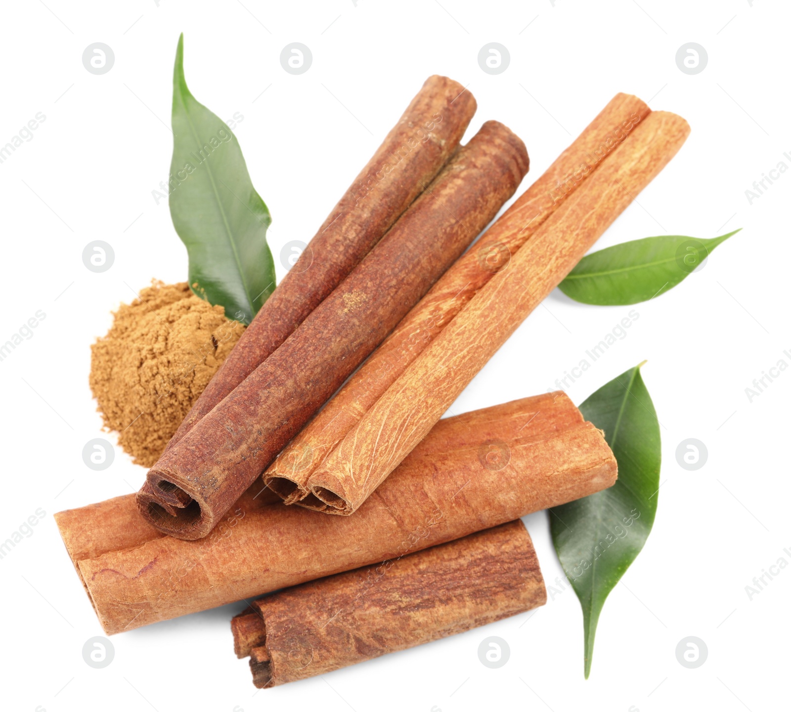 Photo of Dry aromatic cinnamon sticks, powder and green leaves isolated on white