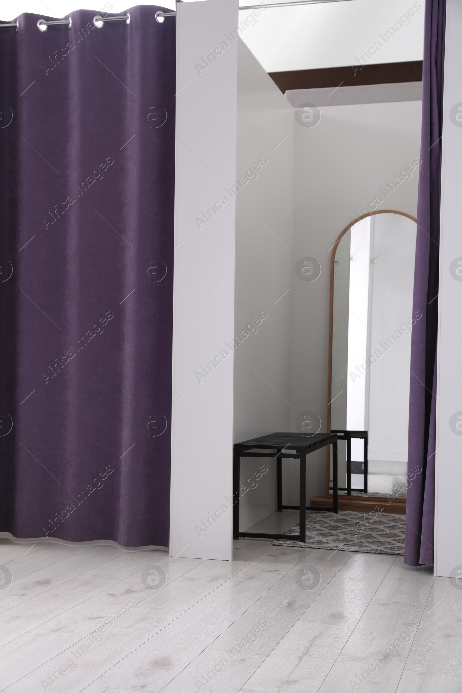 Photo of Empty dressing room in fashion store. Stylish interior