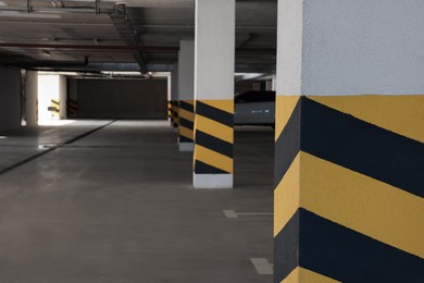 Photo of Car parking garage with warning stripes on columns