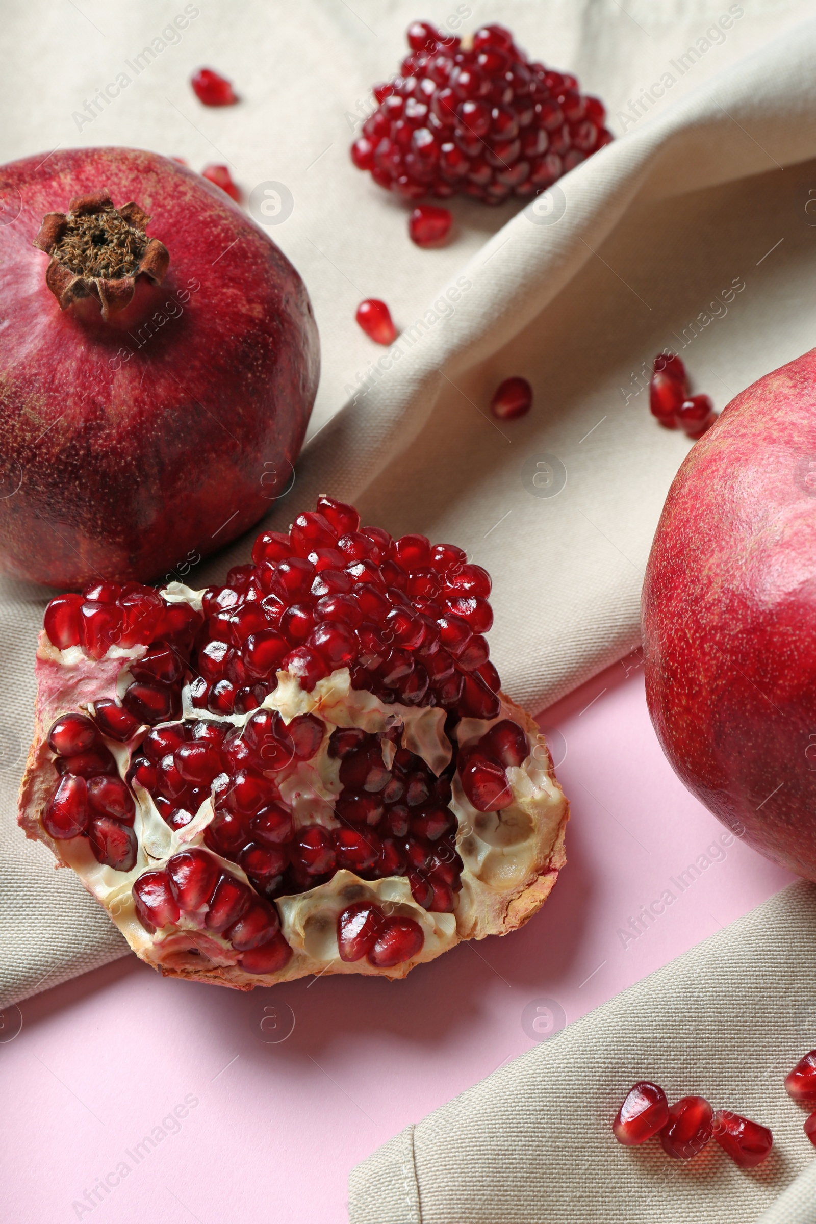 Photo of Delicious red ripe pomegranates on color background