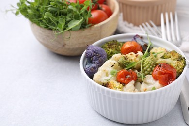 Photo of Delicious salad with cauliflower and tomato served on white table. Space for text