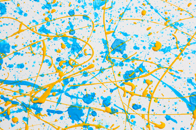 Photo of Colorful paint splashes on white canvas as background. Art and creativity