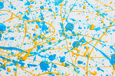 Colorful paint splashes on white canvas as background. Art and creativity