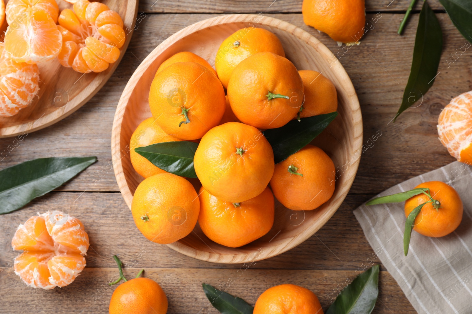 Photo of Fresh ripe tangerines on wooden table, flat lay