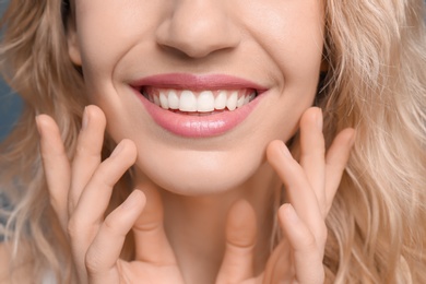 Photo of Young woman with beautiful smile, closeup. Teeth whitening