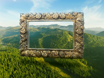 Image of Vintage frame and beautiful mountains under blue sky with clouds