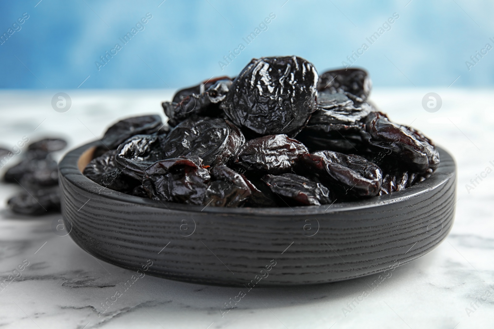 Photo of Plate of sweet dried plums on table, closeup. Healthy fruit