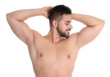 Photo of Young man showing hairless armpits after epilation procedure on white background
