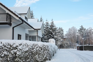 Winter landscape with beautiful houses, trees and bushes in morning