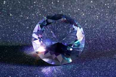 Beautiful dazzling diamond on glitter background, closeup