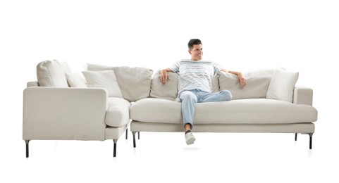 Man relaxing on comfortable sofa against white background