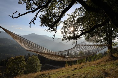 Comfortable net hammock in mountains on sunny day