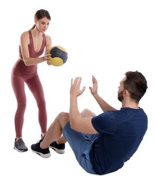 Photo of Athletic couple doing exercise with medicine ball on white background