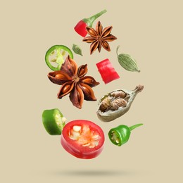 Image of Different spices falling on dark beige background