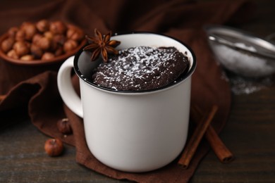 Photo of Tasty chocolate mug pie on wooden table, closeup. Microwave cake recipe