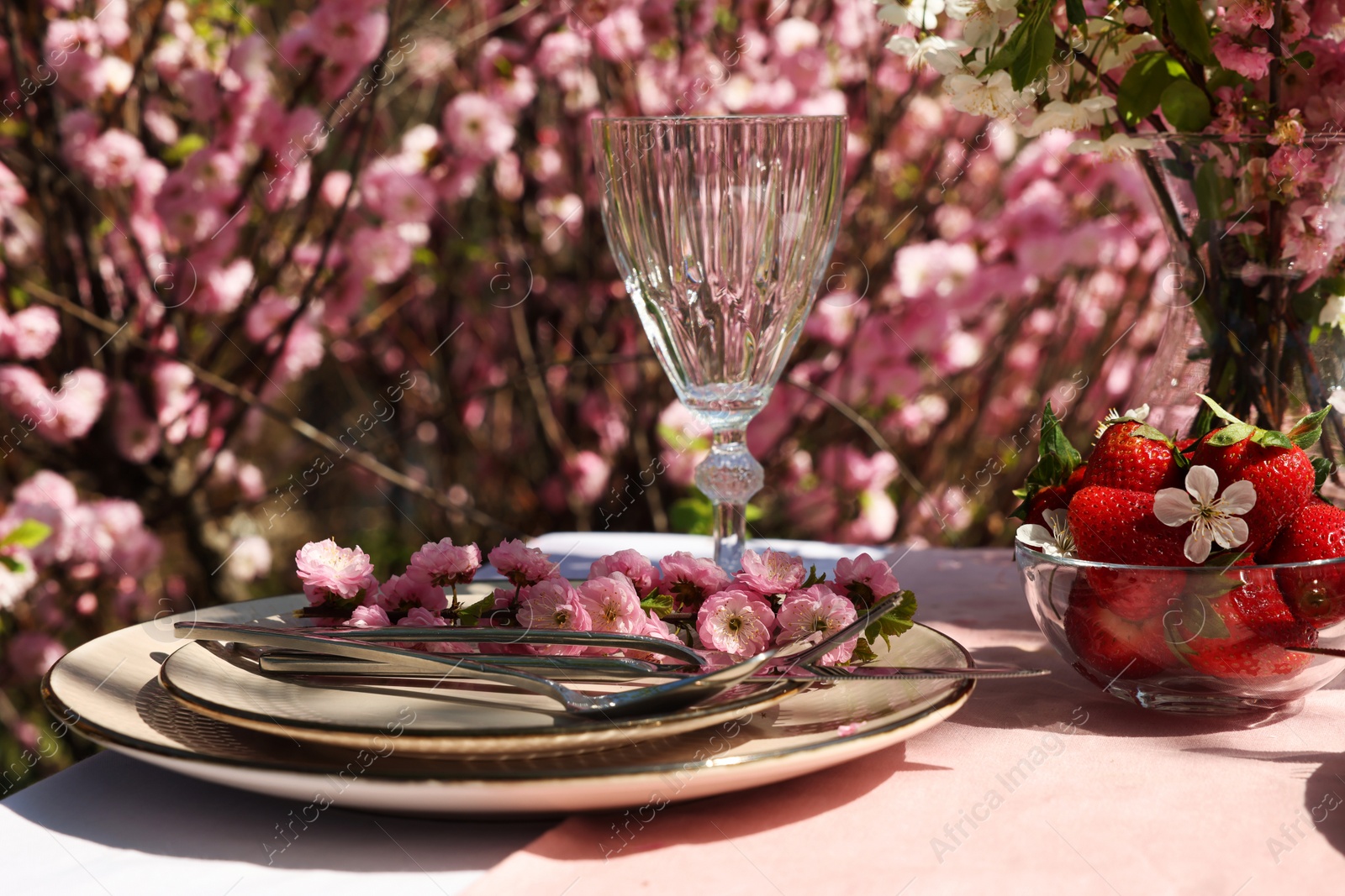 Photo of Stylish table setting with beautiful spring flowers in garden