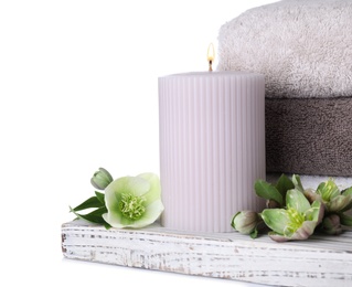 Photo of Composition with towels, candle and flowers isolated on white. Spa treatment