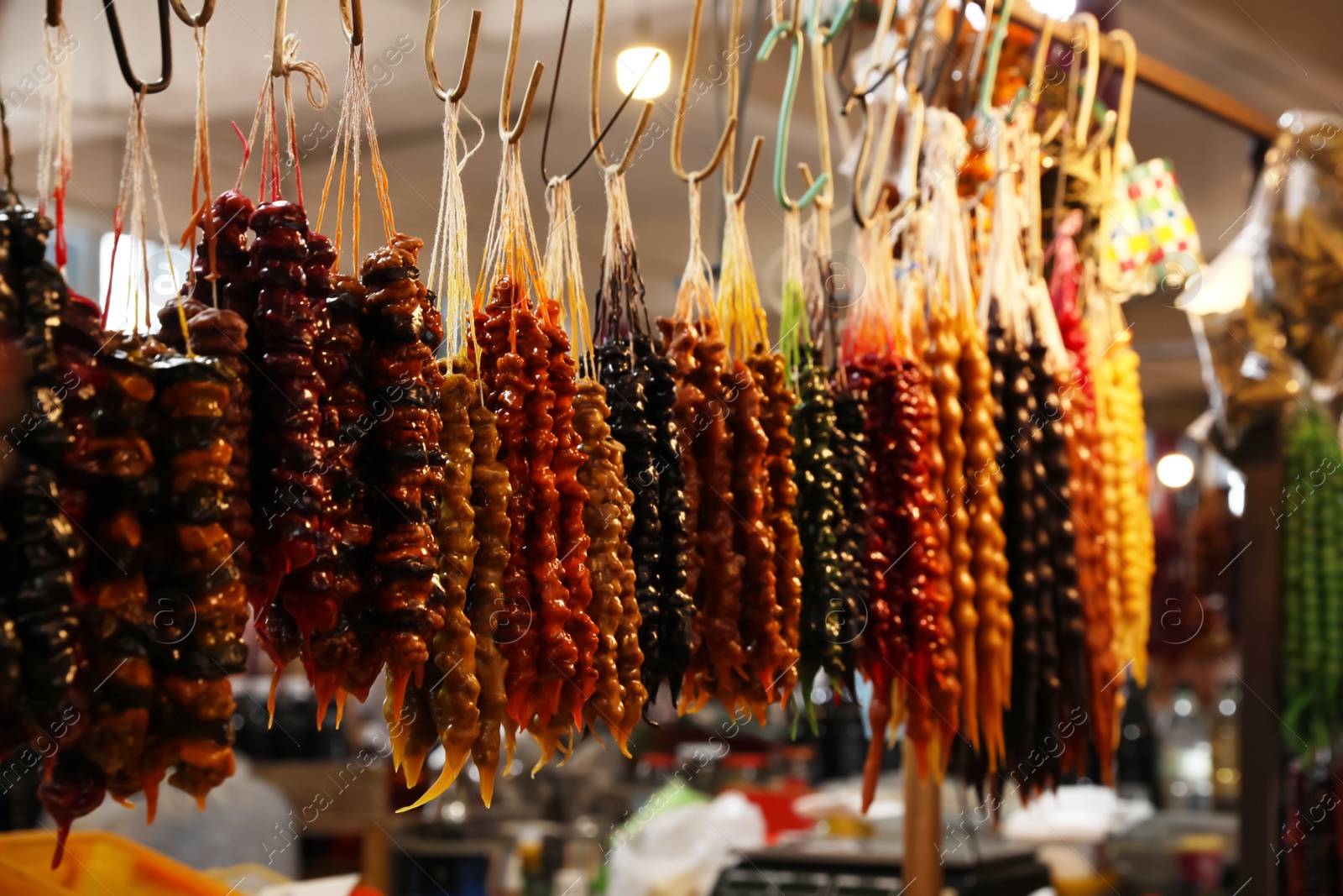 Photo of Bunches of different delicious churchkhelas at market