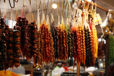 Photo of Bunches of different delicious churchkhelas at market