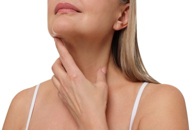 Mature woman touching her neck on white background, closeup