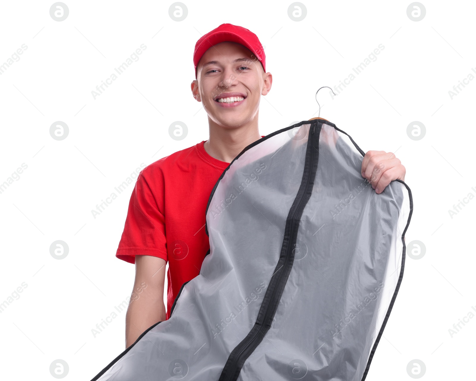 Photo of Dry-cleaning delivery. Happy courier holding garment cover with clothes on white background