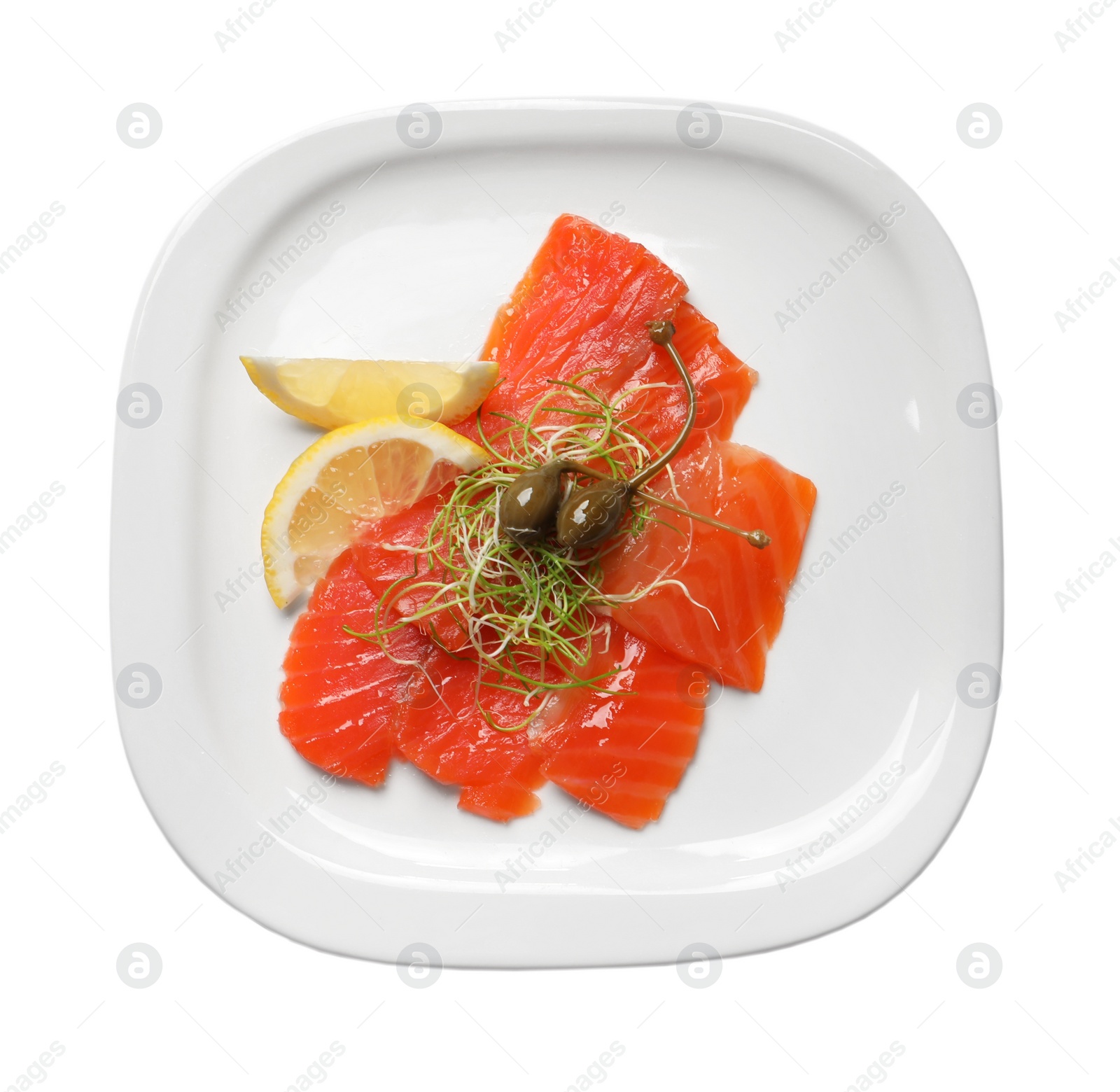 Photo of Salmon carpaccio with capers, microgreens and lemon isolated on white, top view