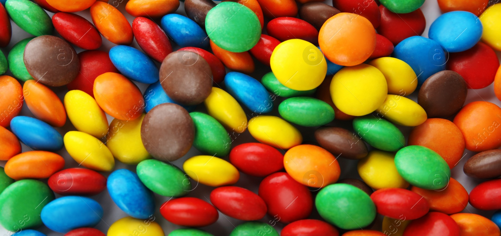 Image of Many colorful candies as background, top view. Banner design 