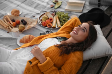 Young woman spending time at picnic outdoors