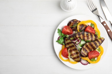 Photo of Delicious salad with roasted eggplant served on white wooden table, flat lay. Space for text