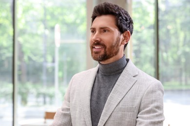 Photo of Portrait of handsome stylish man in office