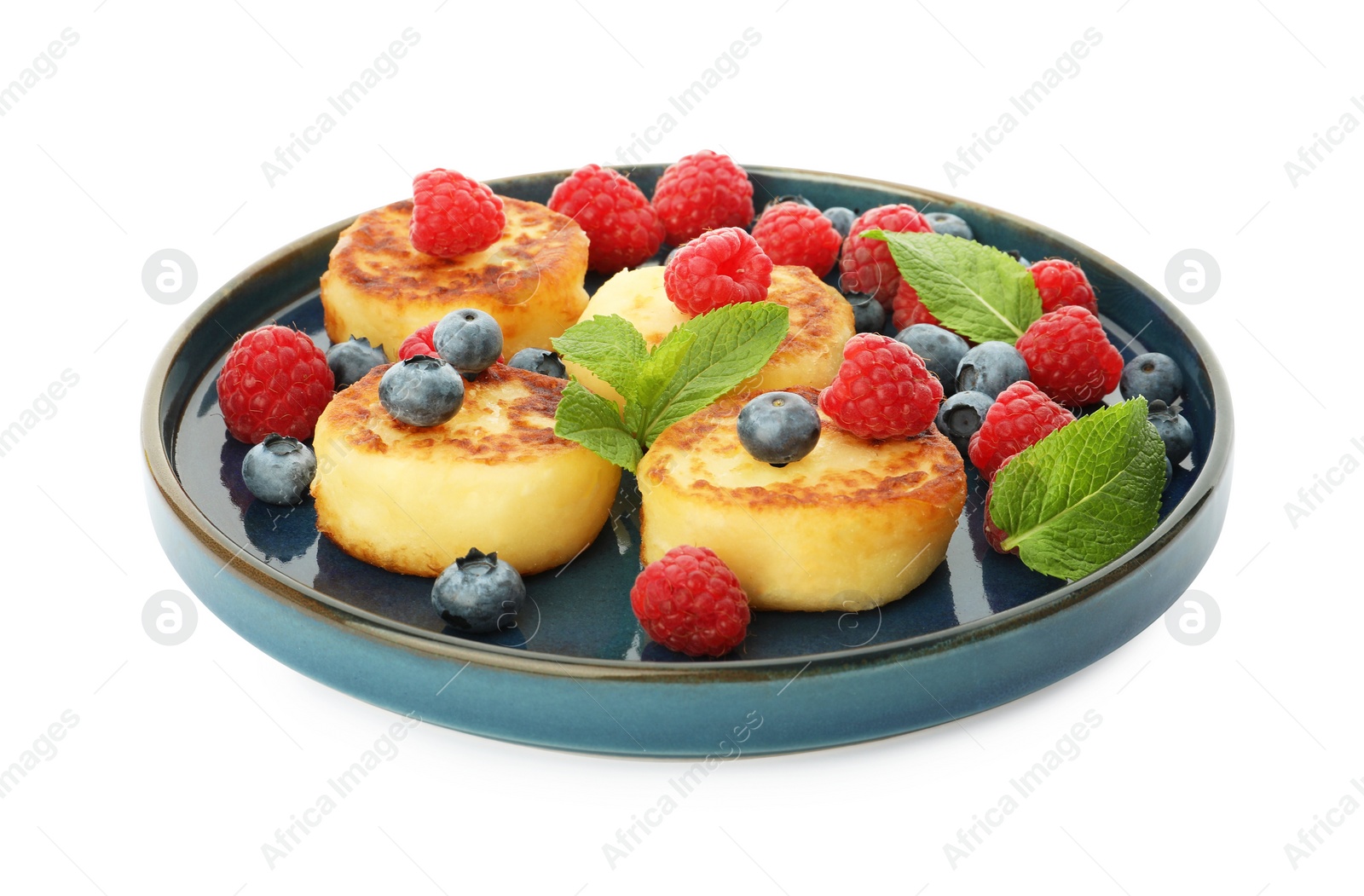 Photo of Plate with delicious cottage cheese pancakes, fresh berries and mint on white background