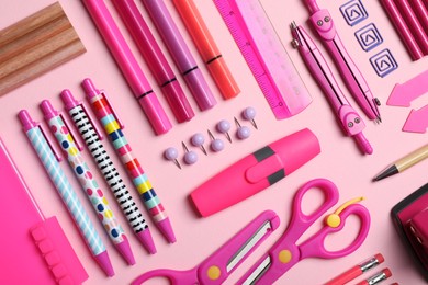 Photo of Flat lay composition with stationery on pink background