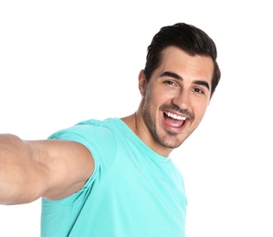 Photo of Happy young man taking selfie on white background