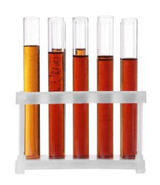 Photo of Test tubes with brown liquid in stand on white background