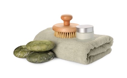 Photo of Composition with folded towel and spa stones on white background