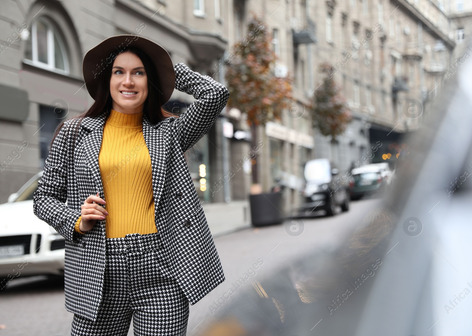 Photo of Beautiful woman in stylish suit on city street