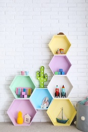 Child room interior with colorful shelves near brick wall