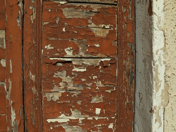 Old door with shabby paint outdoors, closeup