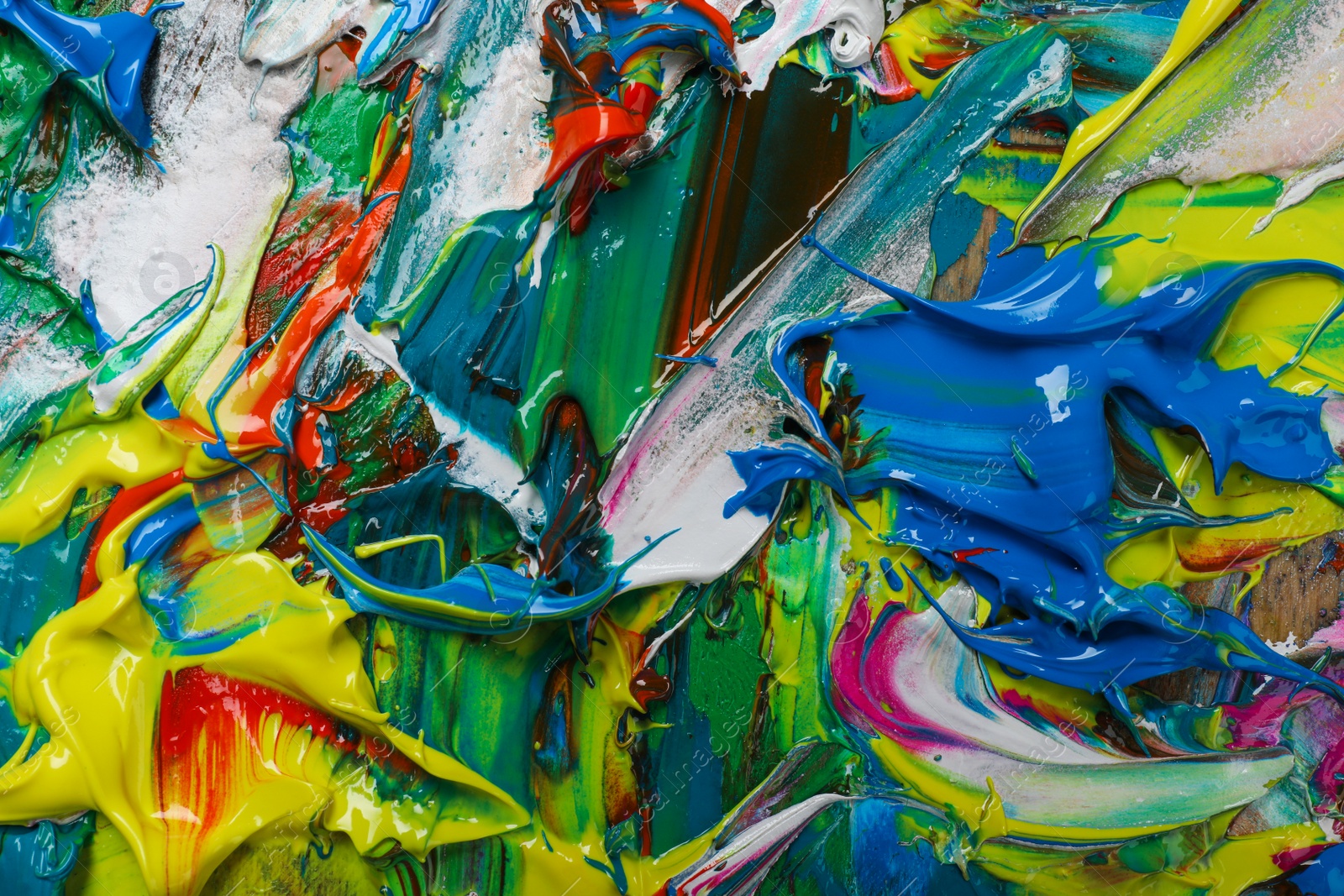 Photo of Abstract colorful acrylic paint as background, top view