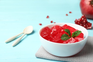 Photo of Composition with red jelly in  bowl on table. Space for text