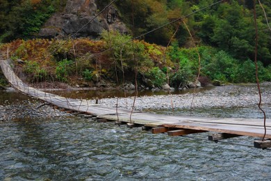 Photo of Beautiful view on wooden bridge over river in mountains