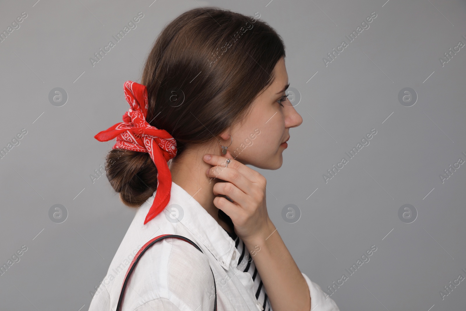 Photo of Young woman with stylish bandana on grey background