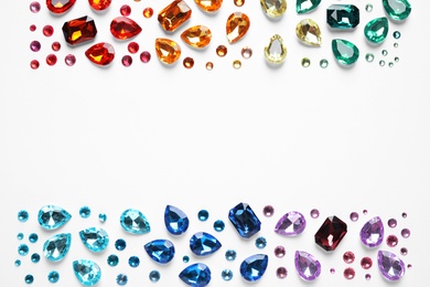 Photo of Frame made of different beautiful gemstones on white background, top view. Space for text